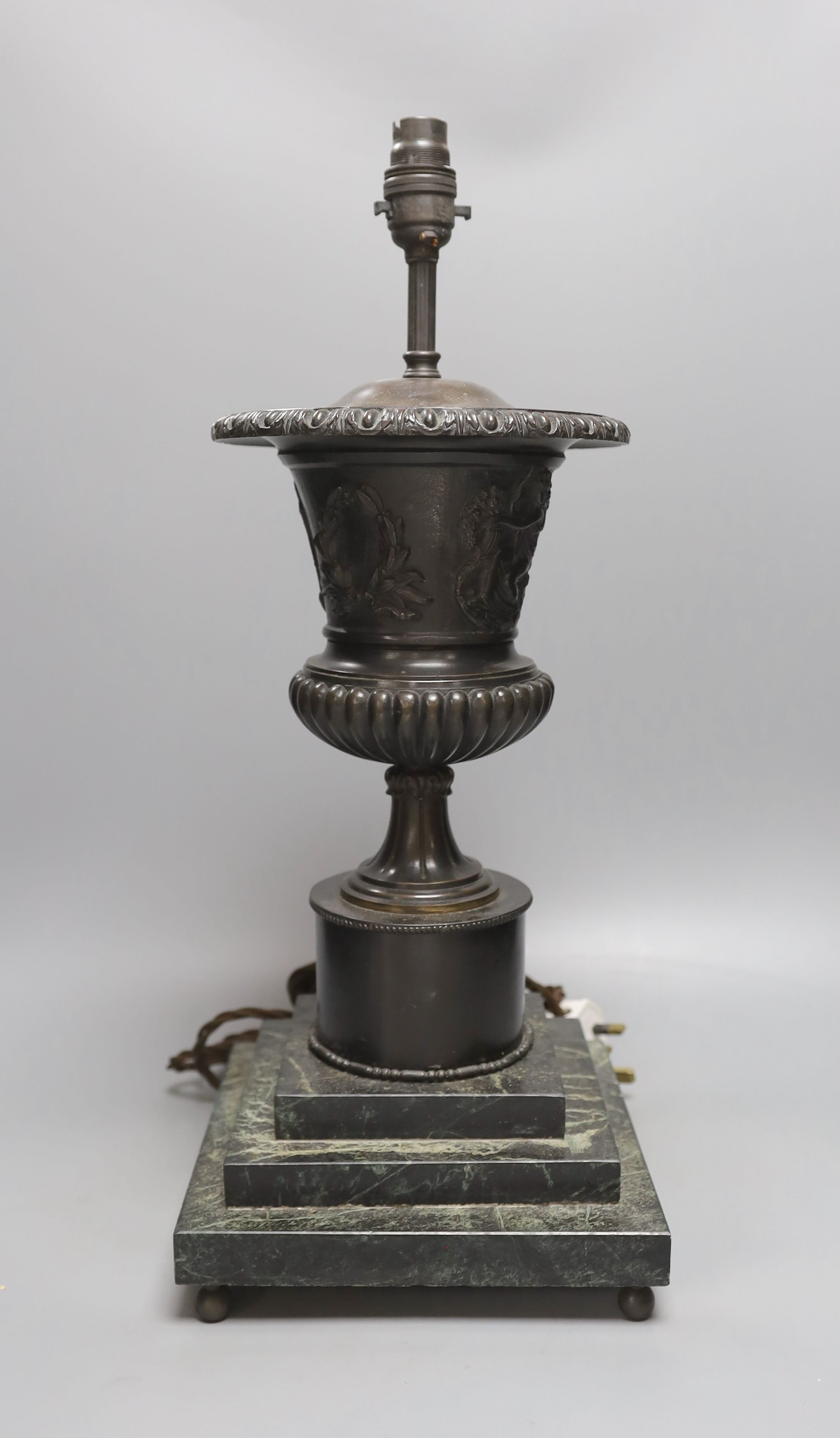 A bronze urn lamp on stepped serpentine base. Total height 49cm